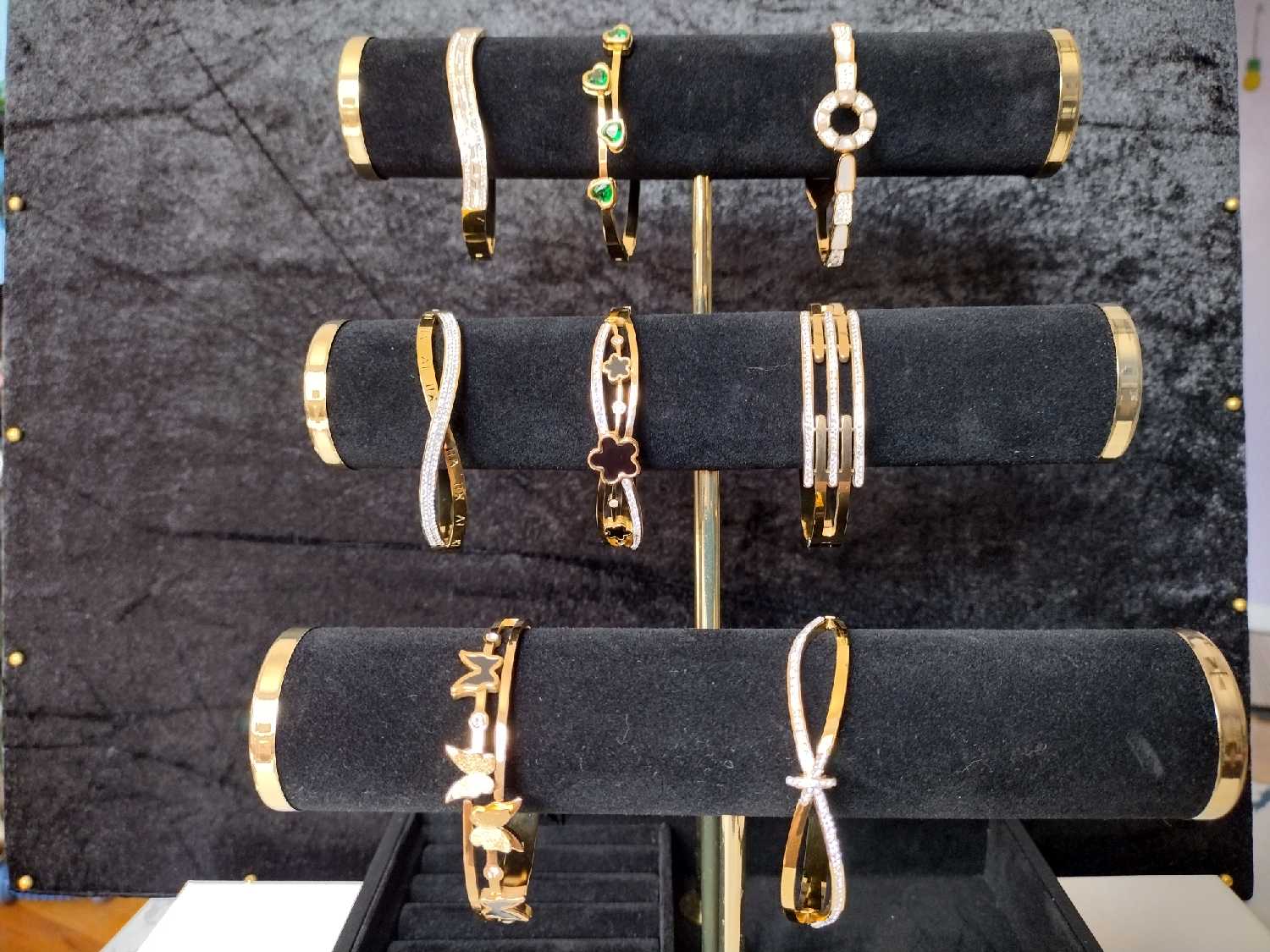 Bracelets with green accents, floral shapes, butterflies and looping details