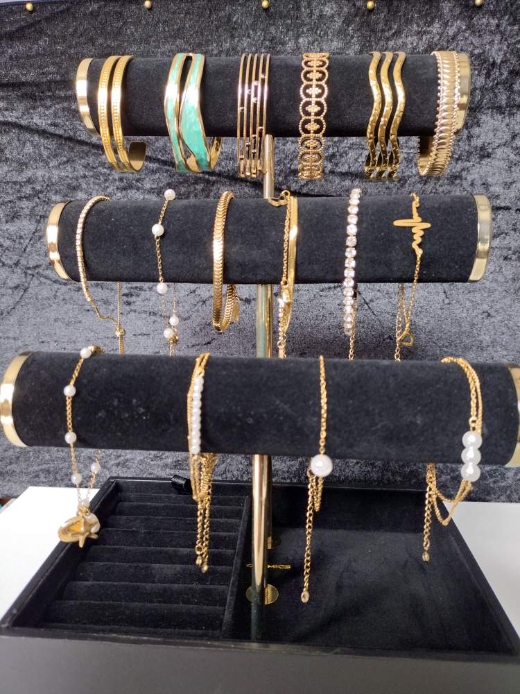 Bangles and delicate chain bracelets with white beads and turquoise-colored accents